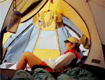 The author, Anne Jeannet, meditating in the tent, while looking at Aconcagua in the distance.